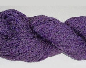 A purple Bartlett Yarn skein on a white surface.